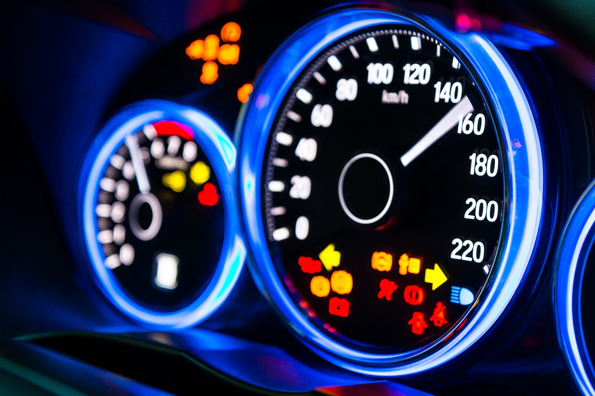 Modern car instrument panel dashboard with blue illuminated display and show all led signs, rev up.